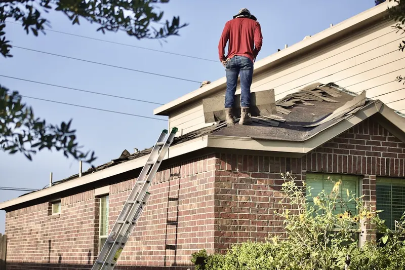 Professional roofer working on a residential roof in English Point
